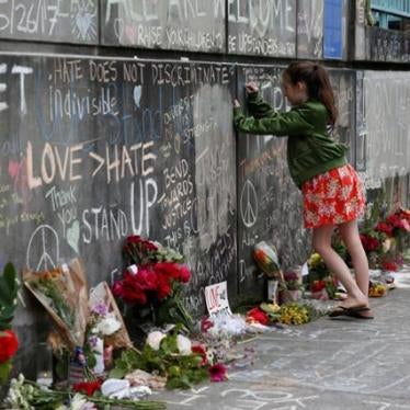 A girl leaves a message at a makeshift memorial for two men who were killed on a commuter train while trying to stop another man from harassing two young women who appeared to be Muslim, in Portland, Oregon, may 29, 2017.