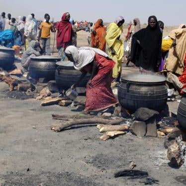 Women cook in pots heated up with firewood at an Internally Displaced Persons (IDP) camp at Dikwa in Borno State, north-eastern Nigeria, on February 2, 2016.