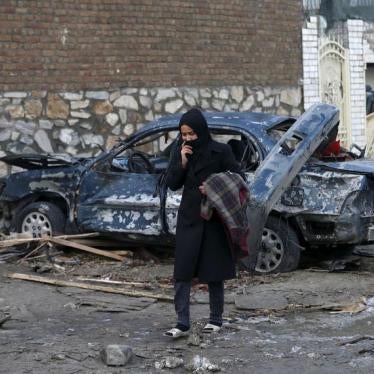 An Afghan woman walks past a damaged car after a suicide attack on French restaurant "Le Jardin" in Kabul, Afghanistan January 2, 2016. 