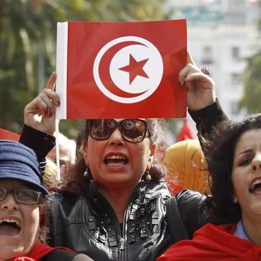 A Tunisian woman holds up a flag during a march to celebrate International Women's Day in Tunis March 8, 2014. © 2014 Reuters