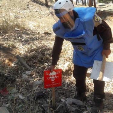 Trained technicians from Syria Civil Defense (“White Helmets”) identify and mark unexploded submunitions and other explosive remnants of war for clearance and destruction in Idlib governorate on June 8, 2017.