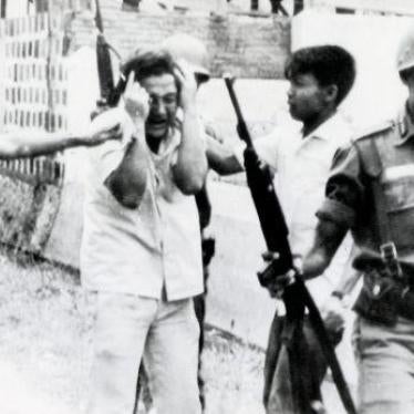A student is led away after a raid on a university in Jakarta, Indonesia in 1965.