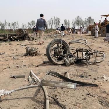 People stand at the site of a Saudi-led air strike on an outskirt of the northwestern city of Saada, Yemen, August 4, 2017. 