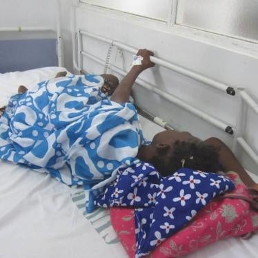During a morphine shortage, a cancer patient in Dakar cluthes onto the railing of her hospital bed because she is in pain and the medication she needs is unavailable.