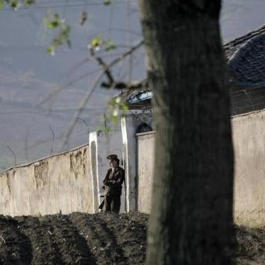 A North Korean soldier stands guard at the entrance of a women’s prison near Chongsong, North Korea, May 31, 2009.