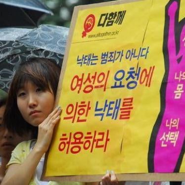 A woman holds a sign at a pro-choice rally at the Cheonggye Plaza in Seoul on August 31, 2010.