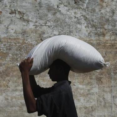 201712asia_pakistan_ngos2 A flood victim carries a sack of flour on his head from a distribution point while heading to his village of Murad Chandio, some 35 km (22 miles) from Dadu in Pakistan's Sindh province January 26, 2011. 