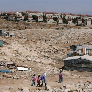 Palestinian Bedouin school children walk towards their tents on September 15, 2010 at their Bedouin camp outside the Israeli West Bank settlement of Ma'ale Adumin. Israel does not recognize the Bedouins’ property claims and has demolished homes and school