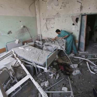 A Palestinian medic inspects a damaged room at Al-Aqsa Martyrs hospital, in Deir el-Balah, central Gaza Strip, after the building was shelled by the Israeli army on July 21, 2014, killing at least 3 people and wounding about 40 others.
