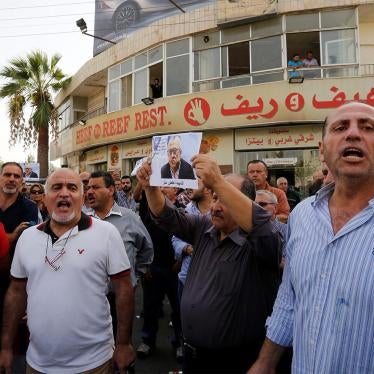 Friends and relatives hold a picture of Jordanian writer Nahed Hattar, who was shot dead, during a sit-in in front of the prime minister's building in Amman, Jordan on September 25, 2016.