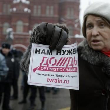 A participant holds a flyer during a protest against the threat of closure to television station Dozhd (TV Rain) in Moscow February 8, 2014. The flyer reads "We need Dozhd".