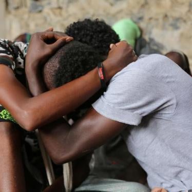 Somali refugees who survived an attack on a boat off Yemen's coast in the Red Sea hug each other as they sit at a detention center in the Houthi-held port of Hodeidah, Yemen, March 22, 2017. 