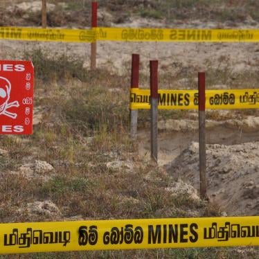 A mine field in Sri Lanka is marked with Danger! Mines! signs and caution tape.