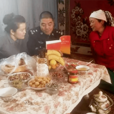 Chinese officials visit a Muslim family.