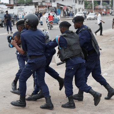 Police detain a protester during a peaceful march after Sunday Mass in front of the Notre Dame Cathedral in Kinshasa, Democratic Republic of Congo, February 25, 2018.