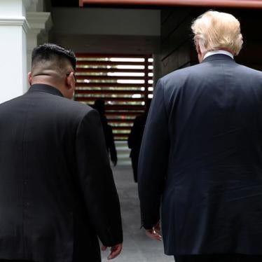 U.S. President Donald Trump and North Korea's leader Kim Jong Un walk together before their working lunch during their summit at the Capella Hotel on the resort island of Sentosa, Singapore June 12, 2018. Picture taken June 12, 2018. REUTERS/Jonathan Erns