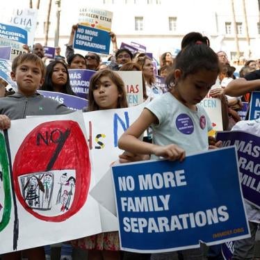 People hold signs to protest against U.S. President Donald Trump's executive order to detain children crossing the southern U.S. border and separating families outside of City Hall in Los Angeles, California, U.S. June 7, 2018.
