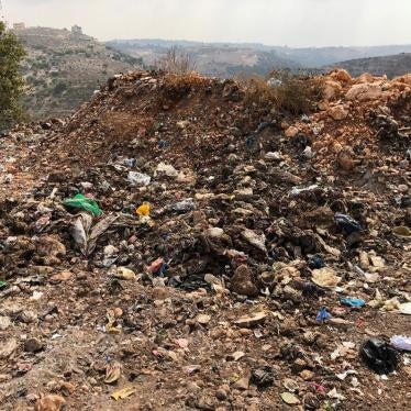 Signs of burning at the al-Qantara dump, including soot from recent burns and ash deposits. 