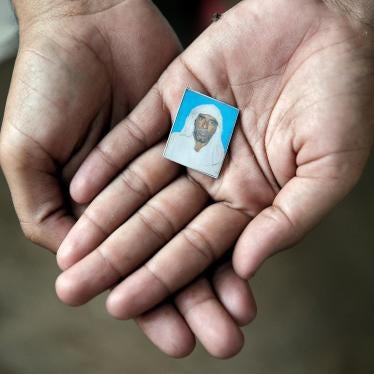 Irshad Khan holds a picture of his father, Pehlu Khan. Irshad, his brother, his father, and two others were attacked by members of a cow protection group while transporting cattle from Rajasthan to Haryana in 2017. Pehlu Khan was killed in the attack. 