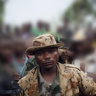 Marcel Habarugira (center) poses for a photograph in Ngululu, 80 kilometers northwest of Goma, Democratic Republic of Congo, 2012.
