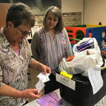 Volunteers at the Wisbech food bank, Cambridgeshire make up an emergency parcel suitable for a large family, April 20. This food bank can sometimes offer families with children an additional £5 voucher to be redeemed at the local butcher or greengrocers. 