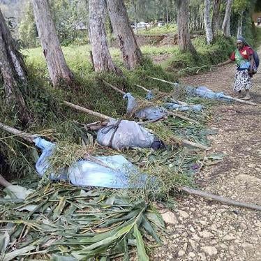 Local residents stand by the bodies of victims recovered in recent tribal violence, Karida, Papua New Guinea, July 8, 2019.