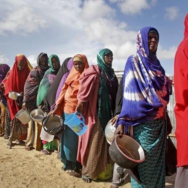 Women who fled drought line up to receive food distributed by local volunteers at a camp for displaced persons in the Daynile neighborhood on the outskirts of the Somalian capital Mogadishu