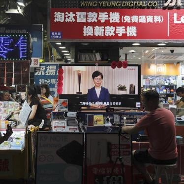 People watch the television as Hong Kong Chief Executive Carrie Lam makes an announcement on the extradition bill, at a retailer in Hong Kong.