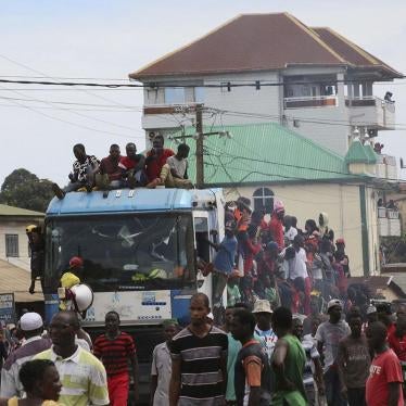 People protest on the streets of Conakry, Guinea, Thursday, Oct. 24, 2019. 