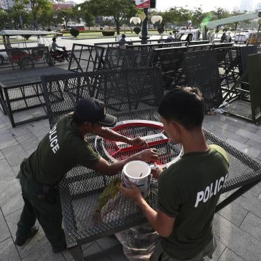 Police officers paint on barricades at the park near the residence of Cambodian's Prime Minister Hun Sen in the preparation for Saturday's Independent Day event, in Phnom Penh, Cambodia, Tuesday, Nov. 5, 2019. 