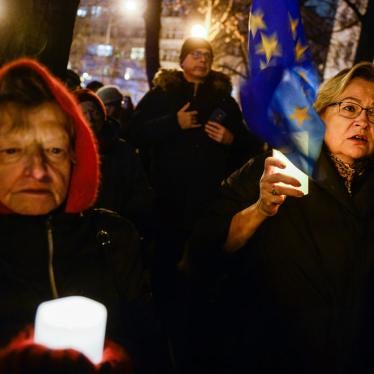 Women hold candles and European Union flag as they demonstrate in solidarity with Polish judges in front of the Ministry of Justice on December 1, 2019 in Warsaw, Poland.