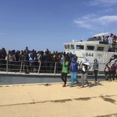 Photo released by the Libyan Coast Guard showing people disembarking in Libya after being intercepted offshore, June 24, 2018. 
