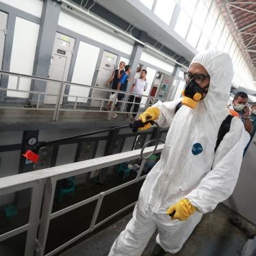 An Indonesian Red Cross worker wearing a protective suit sprays disinfectant at a prison in Bandung, West Java, Indonesia, March 23, 2020.