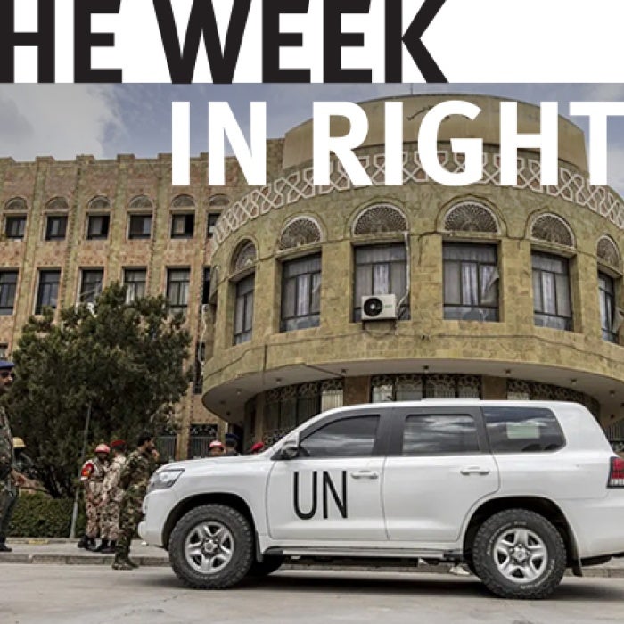 United Nations vehicle is stopped in front of military personnel. 