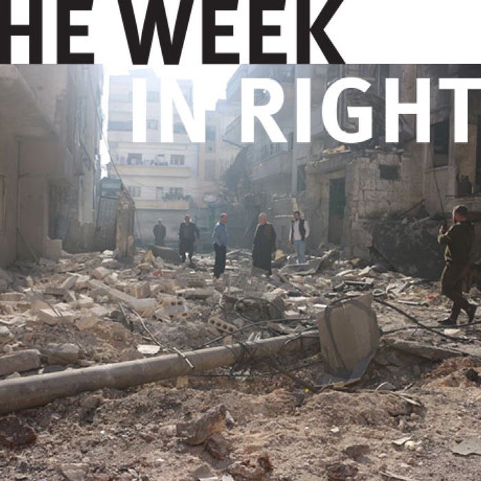 People look over rubble in Syria.