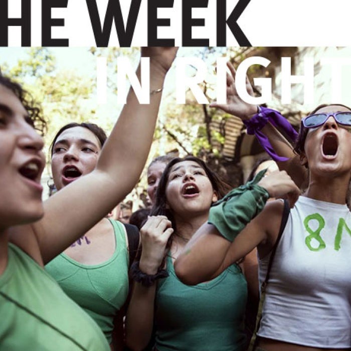 Crowds cheer at a protest. 