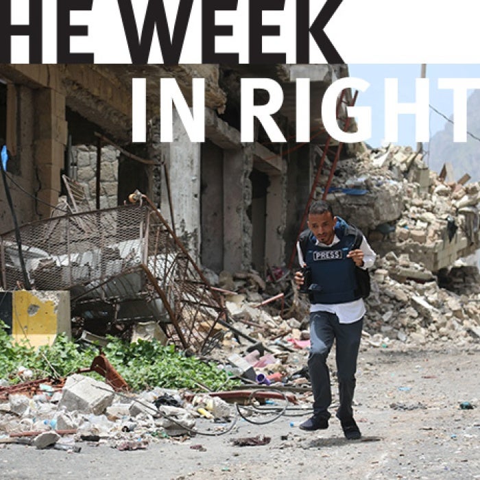 Figure walks through rubble in Yemen.